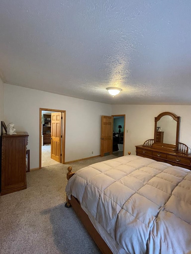 carpeted bedroom featuring a textured ceiling