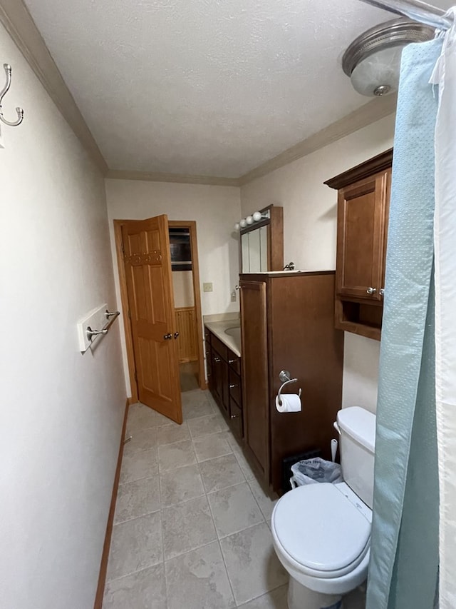 bathroom featuring tile patterned floors, vanity, a textured ceiling, and toilet