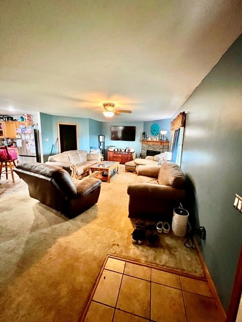 19 Angel Trl, Duke Center, PA 16729 - living room featuring carpet flooring, a stone fireplace, and a ceiling fan