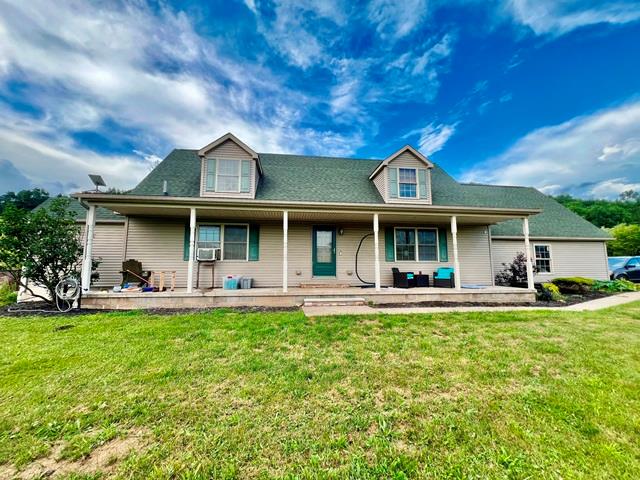 19 Angel Trl, Duke Center, PA 16729 - country-style home with a front lawn, covered porch, and cooling unit