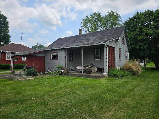 409 E Main St, Elkland, PA 16920 - rear view of property featuring a chimney, a yard, and a patio area