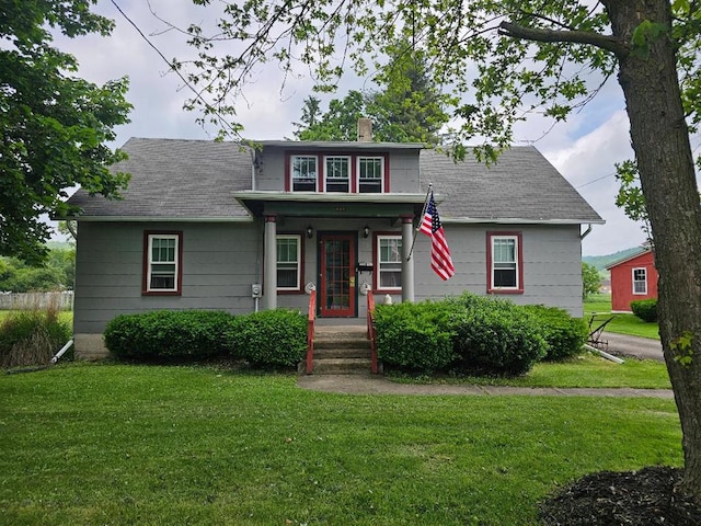 409 E Main St, Elkland, PA 16920 - bungalow-style house featuring a front lawn, a chimney, covered porch, and roof with shingles