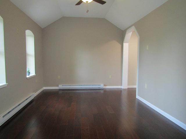 spare room featuring ceiling fan, dark hardwood / wood-style flooring, a baseboard radiator, and vaulted ceiling