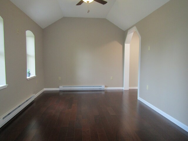 empty room with dark wood-type flooring, lofted ceiling, and a baseboard heating unit