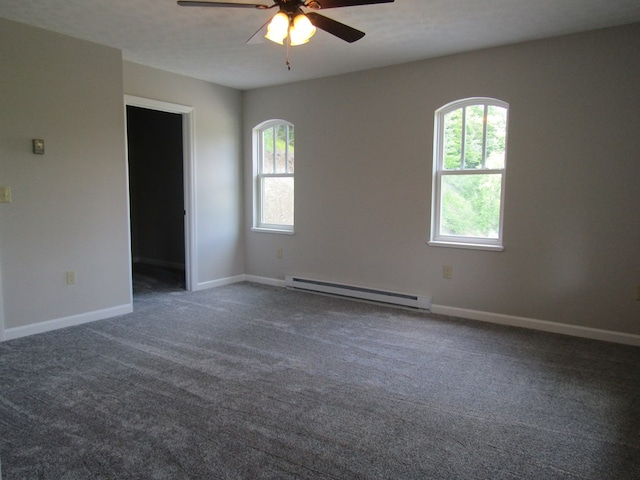 carpeted spare room with ceiling fan and baseboard heating