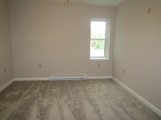 unfurnished room with baseboard heating and carpet flooring