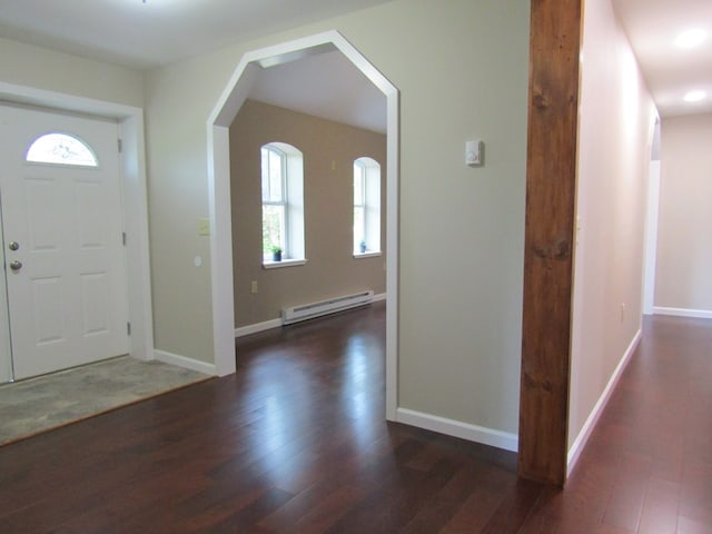 foyer entrance featuring dark wood-type flooring and a baseboard radiator