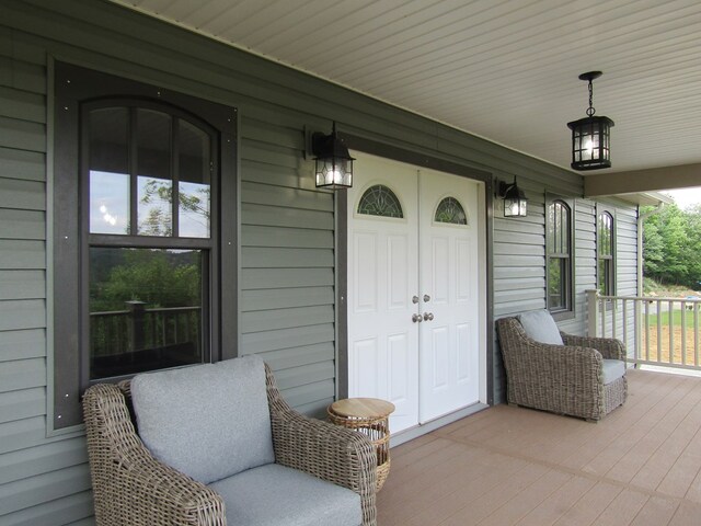 view of exterior entry with covered porch