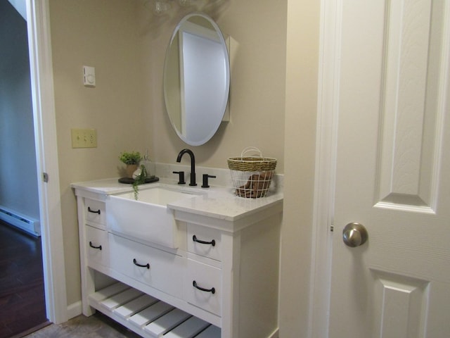 bathroom with vanity and a baseboard radiator