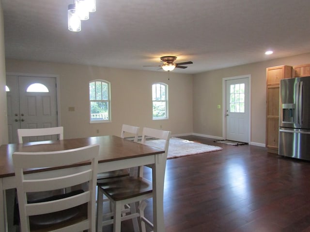 unfurnished dining area featuring dark wood-type flooring, ceiling fan, and a healthy amount of sunlight