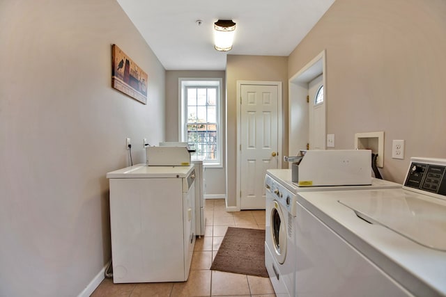 laundry room with independent washer and dryer and light tile patterned floors