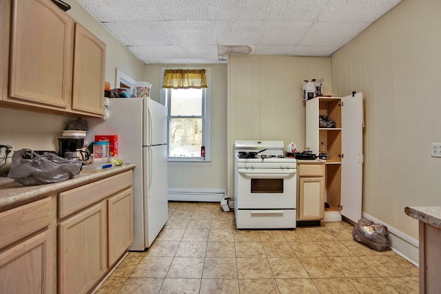 kitchen featuring a paneled ceiling, light brown cabinetry, white appliances, baseboard heating, and light tile patterned flooring