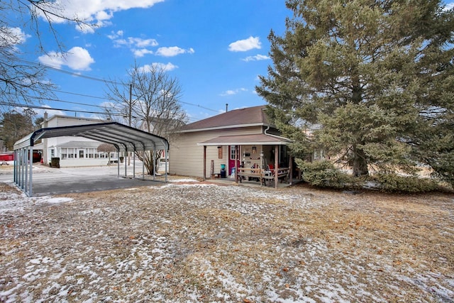 exterior space with a carport and a porch