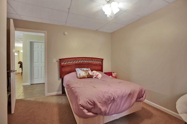 carpeted bedroom with a paneled ceiling