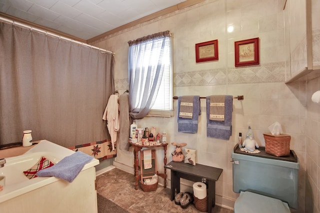 bathroom featuring a shower with shower curtain, tile walls, and toilet