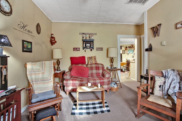 living room with ornamental molding and carpet