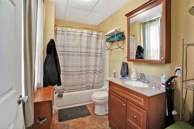 full bathroom with shower / tub combo, tile patterned flooring, toilet, vanity, and a drop ceiling