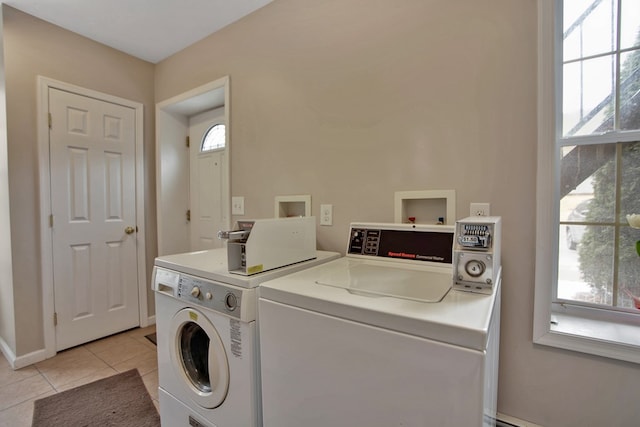 washroom featuring light tile patterned floors and washer and clothes dryer