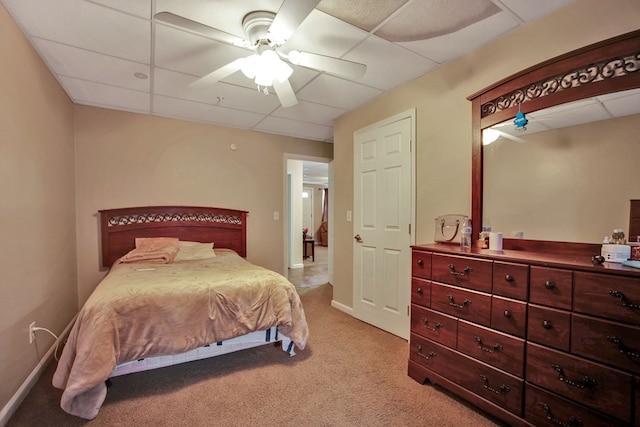 bedroom featuring ceiling fan, a paneled ceiling, and light colored carpet