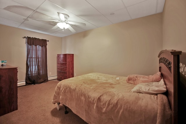 bedroom featuring baseboard heating, ceiling fan, carpet, and a drop ceiling