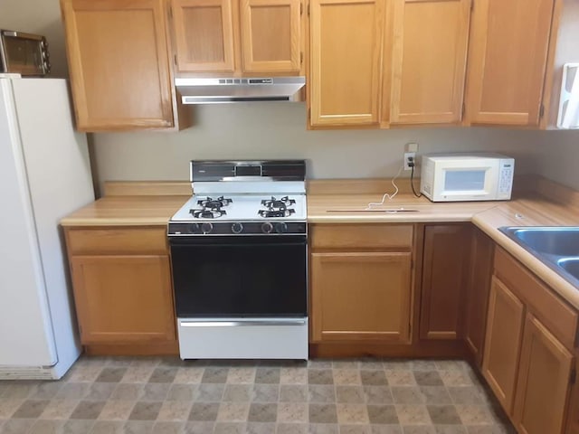 kitchen with ventilation hood, white appliances, and sink