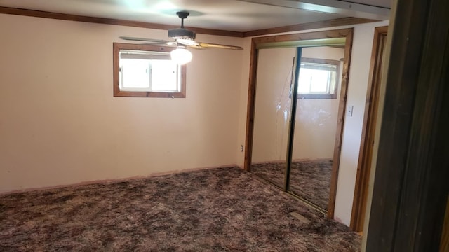 unfurnished bedroom with carpet flooring, a closet, and ceiling fan