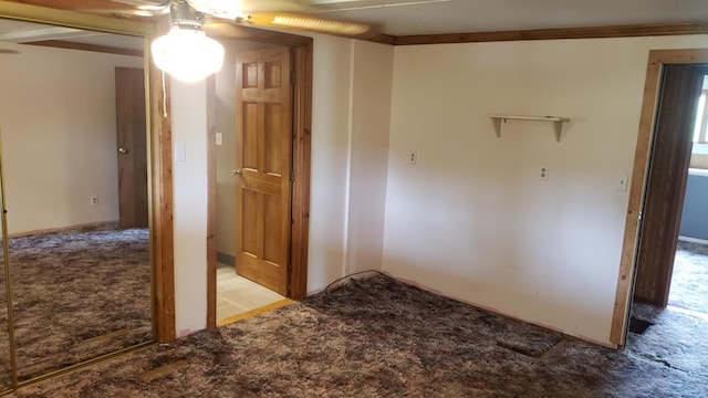 hallway with crown molding and light carpet