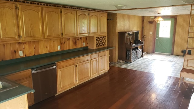 kitchen with pendant lighting, dishwasher, dark hardwood / wood-style floors, and wooden walls