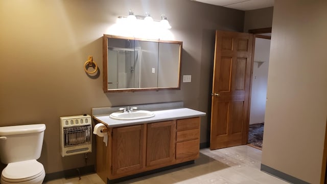 bathroom with tile patterned flooring, vanity, heating unit, and toilet