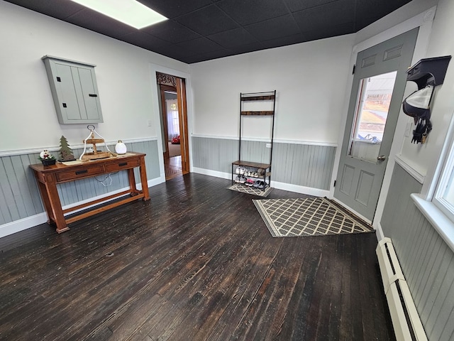 interior space with hardwood / wood-style flooring and a baseboard heating unit