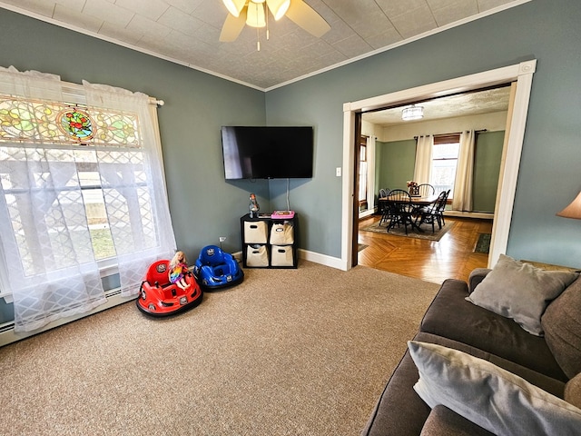 living room with carpet flooring, ceiling fan, and crown molding