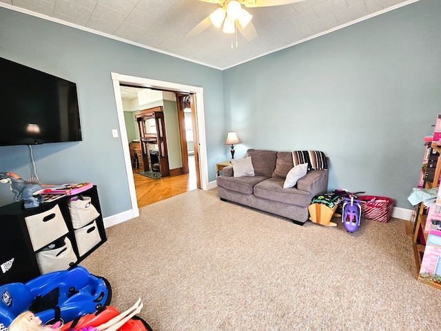 living room featuring ceiling fan and ornamental molding