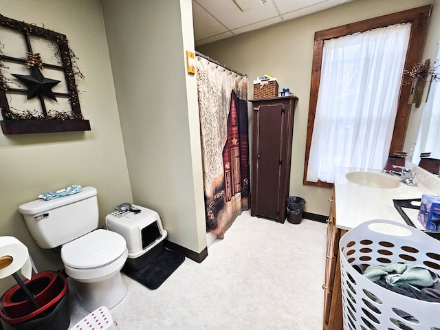 bathroom with vanity, a paneled ceiling, and toilet