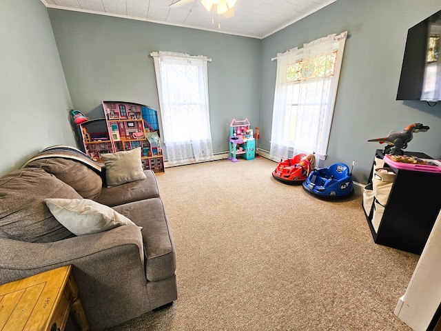 game room featuring carpet floors, ceiling fan, and ornamental molding