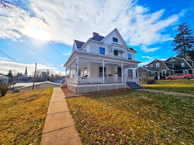 view of front of home with covered porch and a front yard