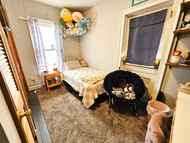 carpeted bedroom with baseboard heating