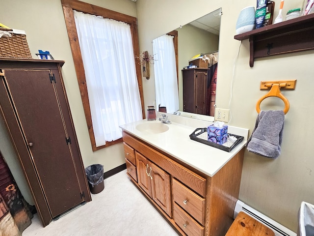 bathroom featuring vanity, plenty of natural light, and baseboard heating