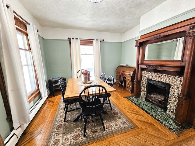 dining room with a textured ceiling and a fireplace