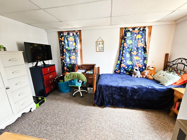 carpeted bedroom featuring a paneled ceiling