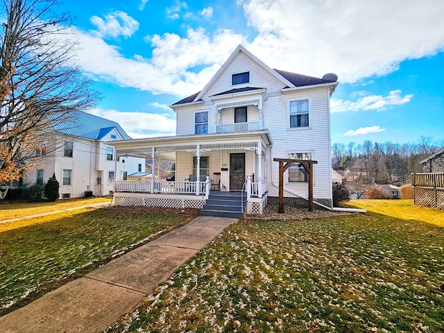 view of front of home with a porch and a front lawn