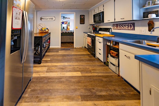 kitchen featuring white cabinetry, stainless steel fridge with ice dispenser, gas stove, sink, and hardwood / wood-style floors