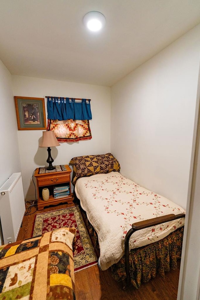 bedroom featuring radiator and wood-type flooring