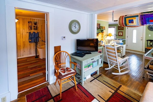 interior space featuring wooden walls and dark hardwood / wood-style flooring