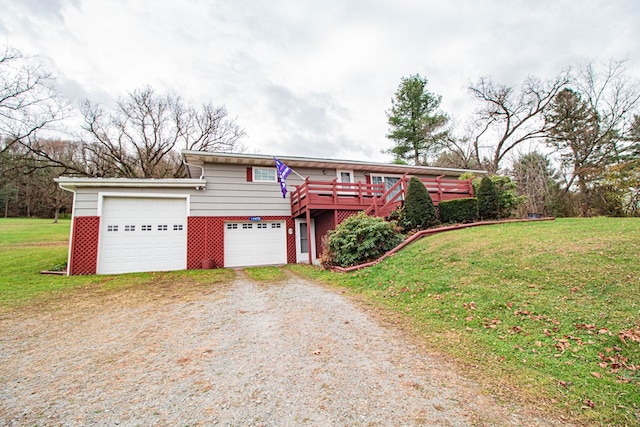 view of front of property featuring a garage, a wooden deck, and a front lawn