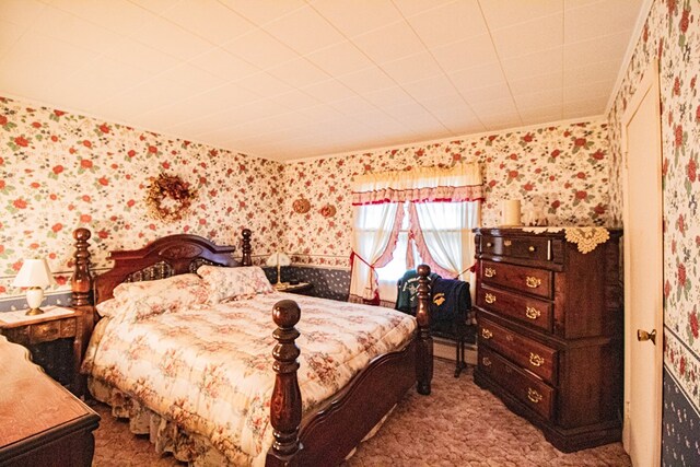 carpeted bedroom featuring crown molding