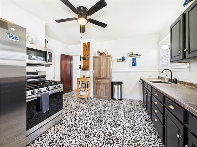 1010 W Main St, Smethport, PA 16749 - kitchen with appliances with stainless steel finishes, ceiling fan, wainscoting, ornamental molding, and dark countertops
