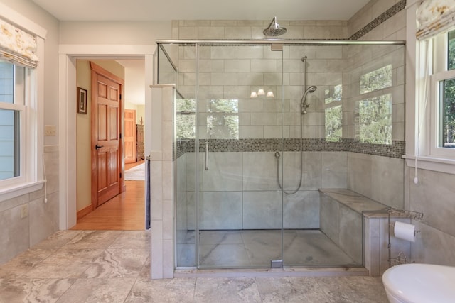 bathroom with a wealth of natural light and walk in shower