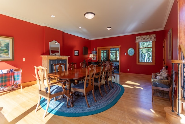 dining room featuring ornamental molding and light hardwood / wood-style flooring