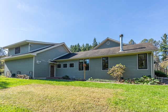 rear view of property with a yard