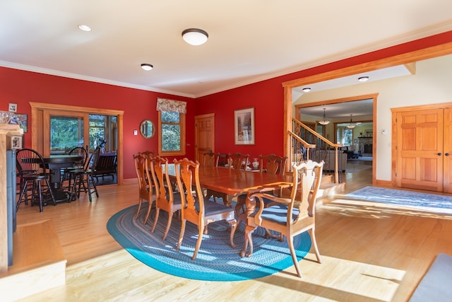 dining room featuring hardwood / wood-style floors and ornamental molding